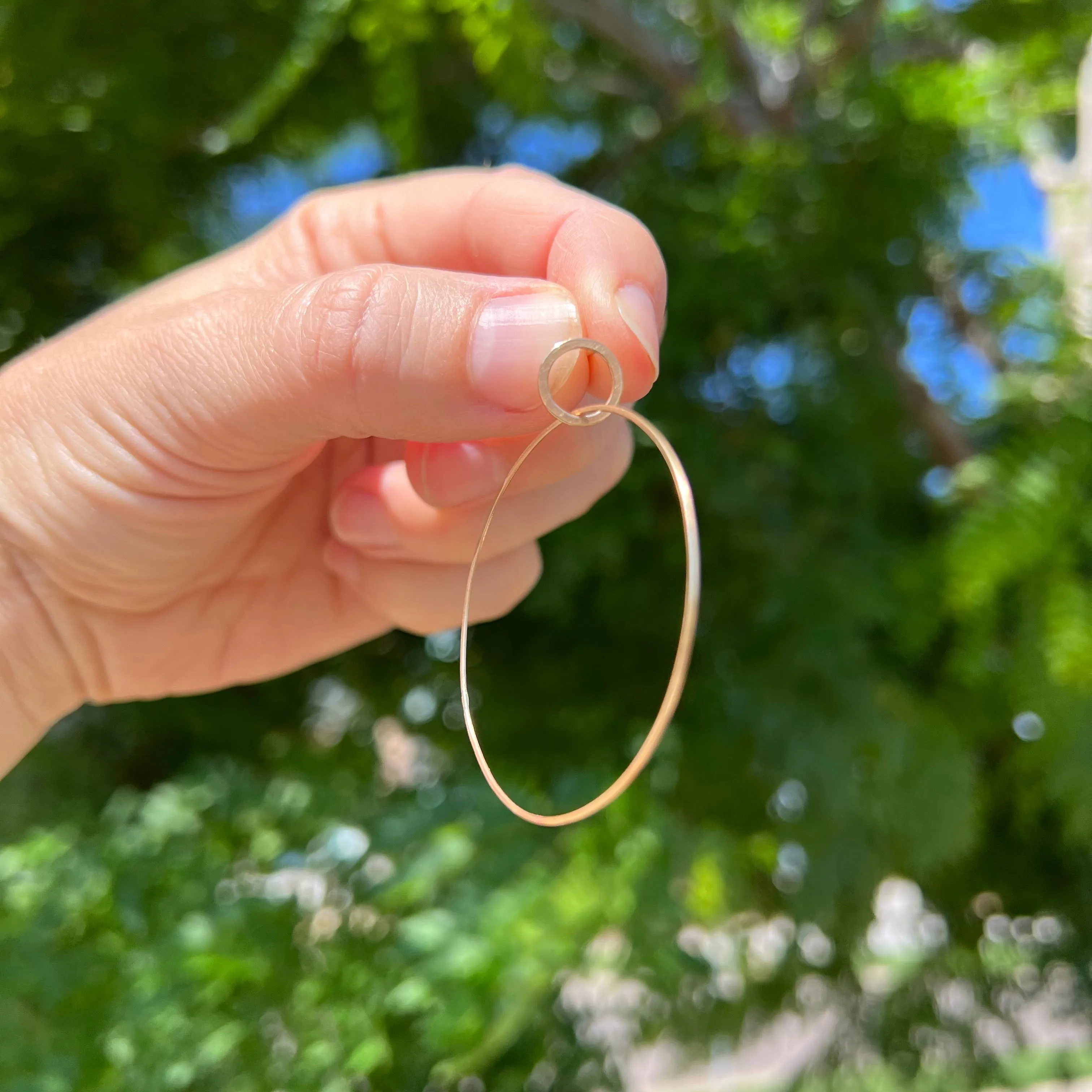 Large single hoop earrings in 18k gold