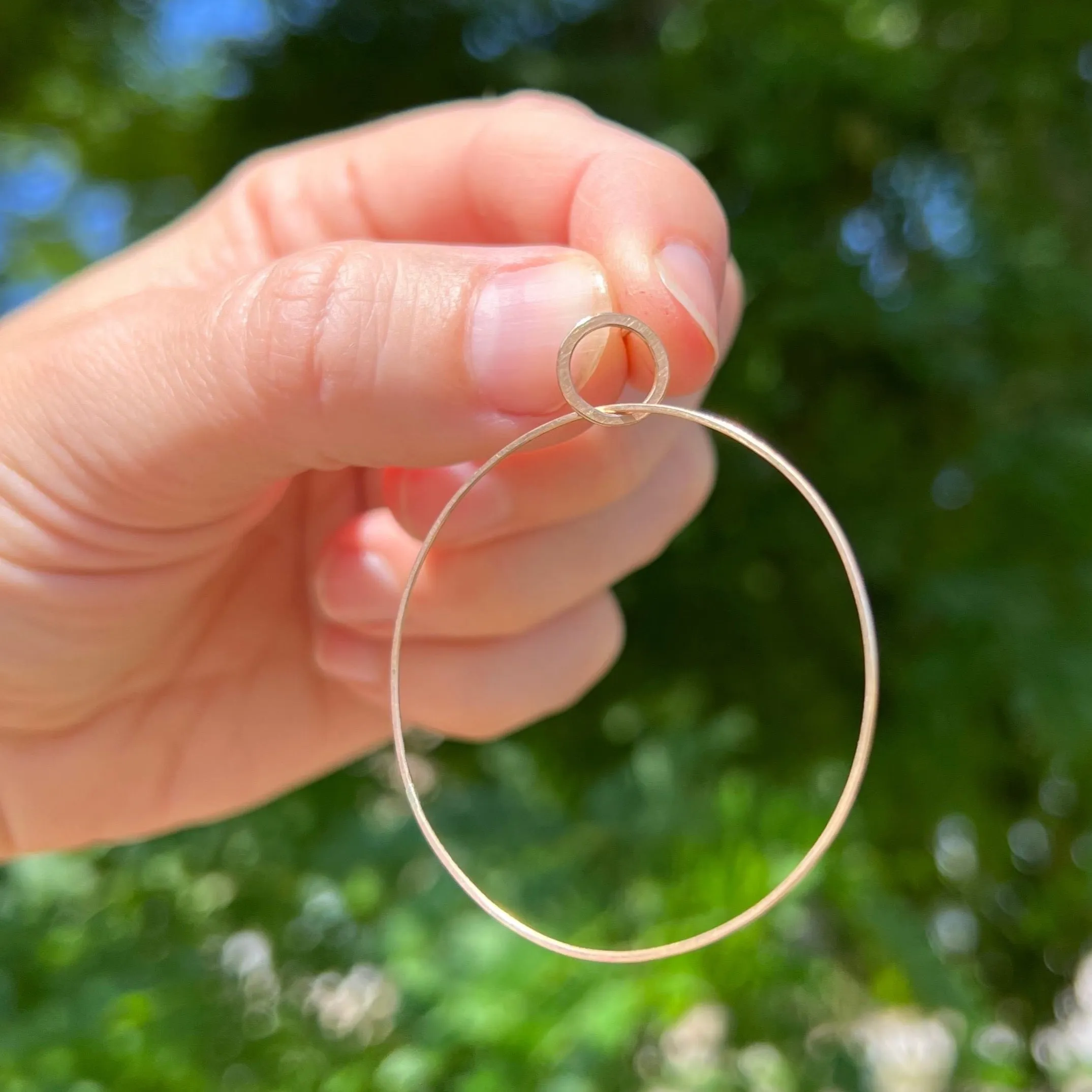 Large single hoop earrings in 18k gold